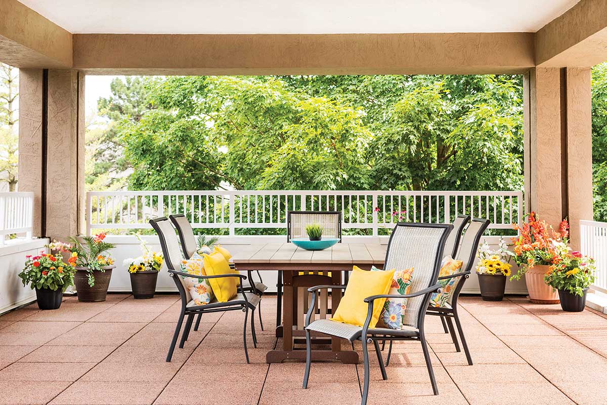Covered patio with outdoor table and chairs.