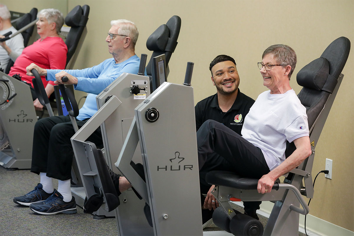 Group of seniors working out with the help of a fitness instructor.