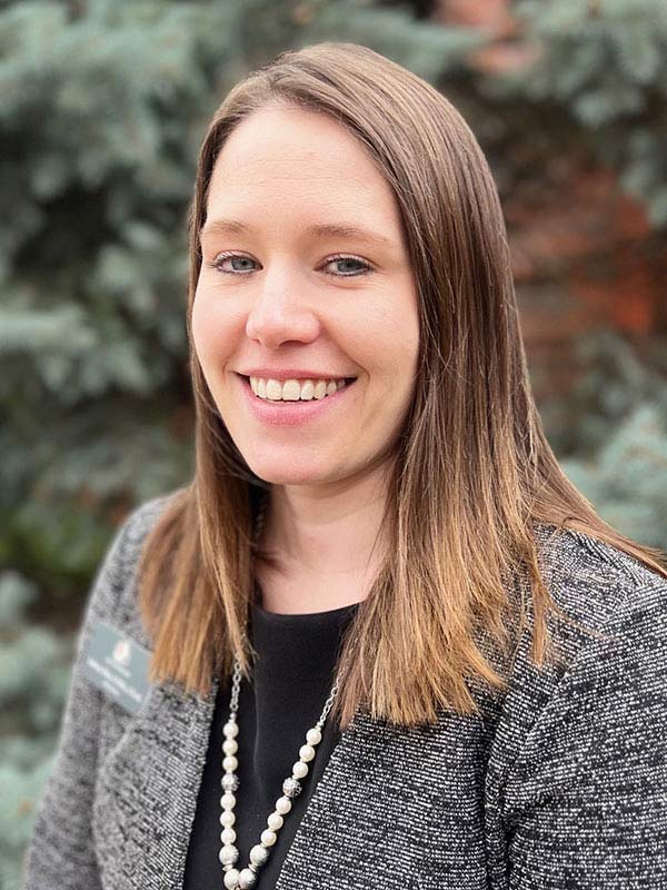 portrait of a person wearing a textured gray blazer
