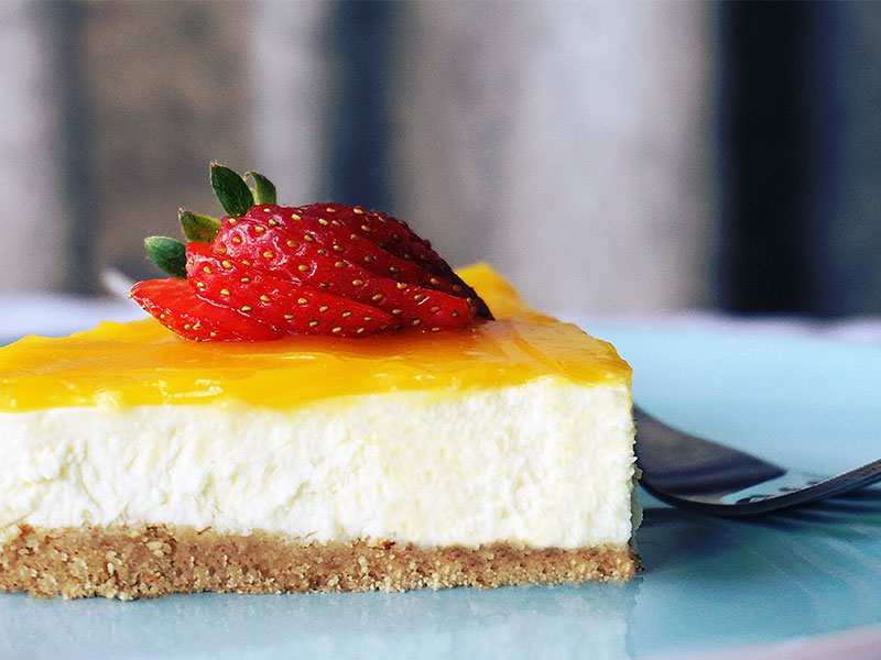 cheesecake with sliced strawberries on top