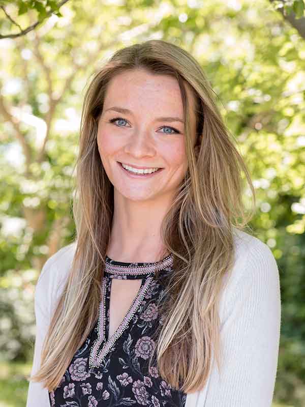 Professional portrait of a person wearing a patterned top