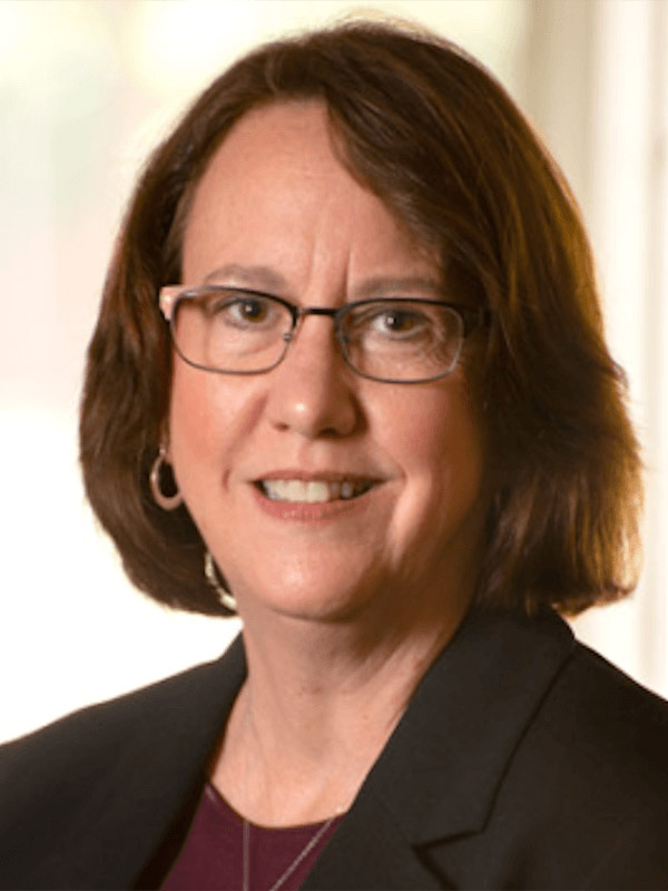 portrait of a person wearing glasses, a dark blazer
