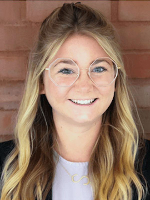 portrait of a person wearing round eyeglasse