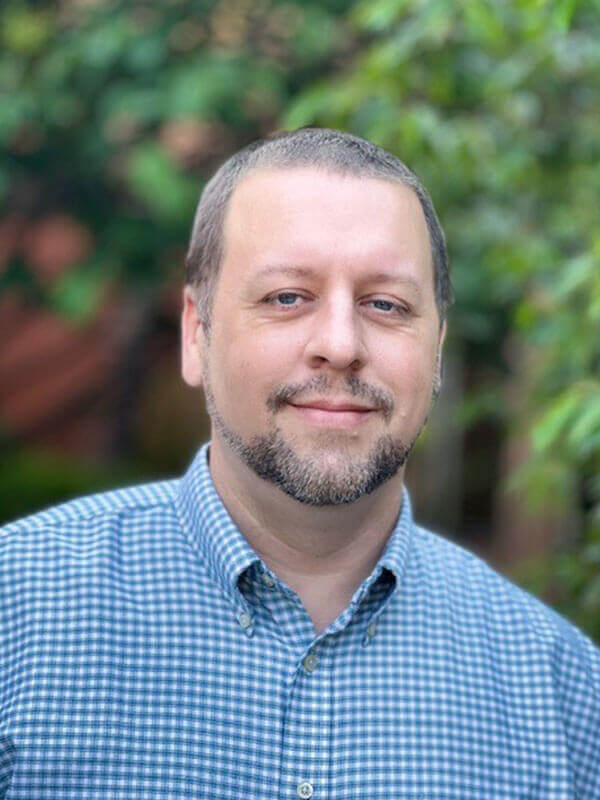 portrait of a person wearing a blue checkered button-down shirt.