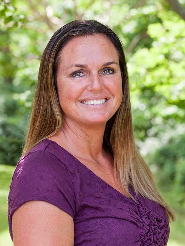 Professional portrait of a person wearing a purple top
