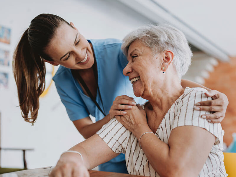 senior woman in respite stay speaking with a nurse