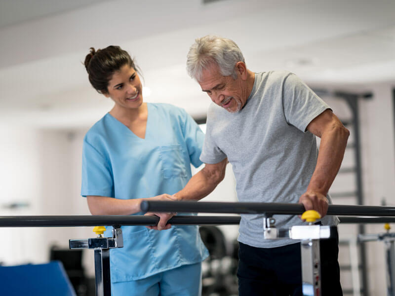 nurse aiding with a resident's rehab procedure