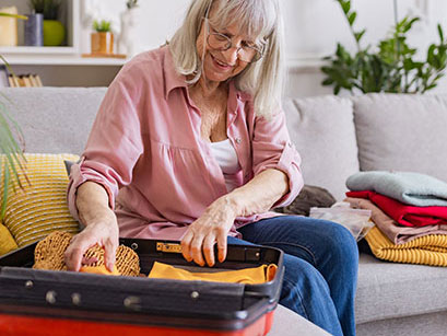 woman packing a suitcase before travel