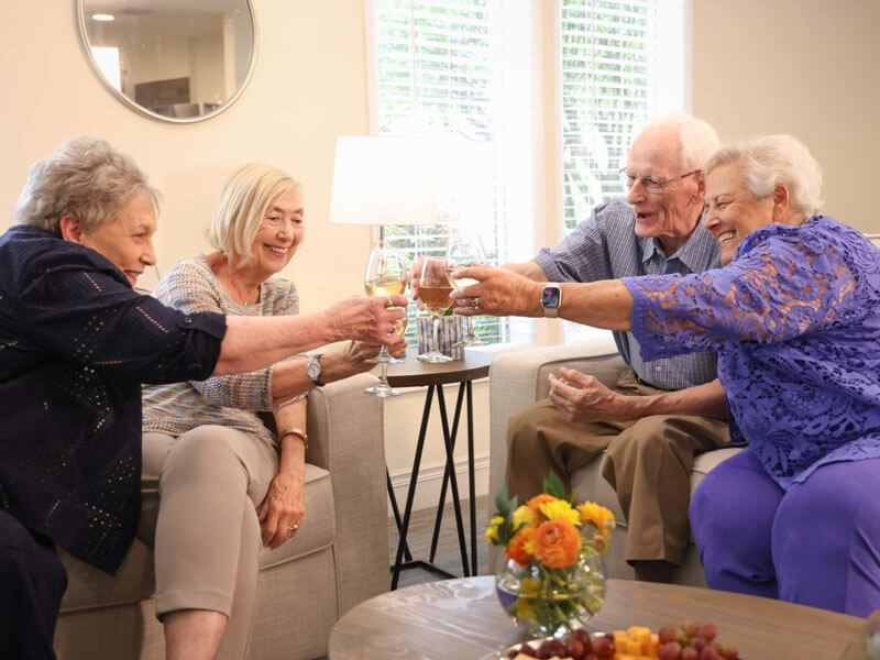 friends gathered in a living room for happy hour during a dining event